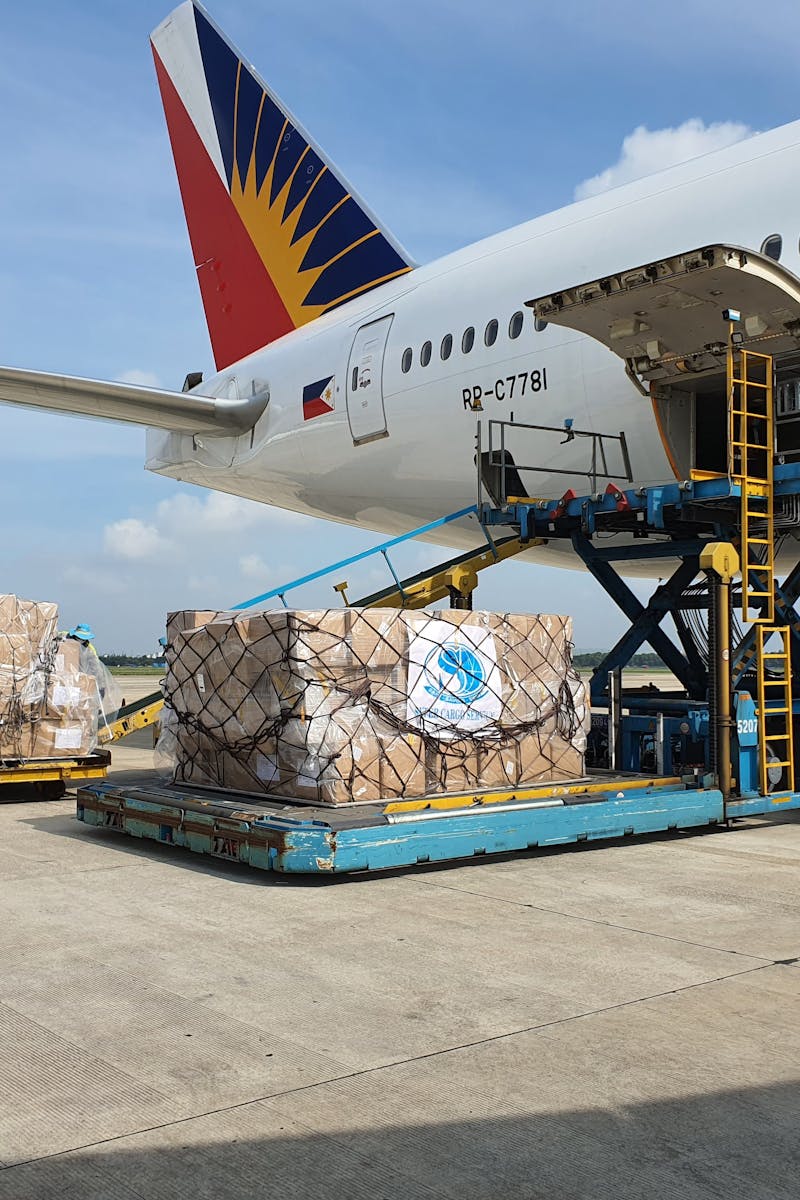 Cargo being loaded onto a commercial airplane at an airport in Ho Chi Minh City, Vietnam.